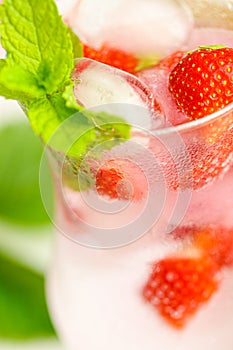 Strawberry drink.Refreshing cocktail. water in glass with ice and strawberries. Mineral water with ice and strawberries