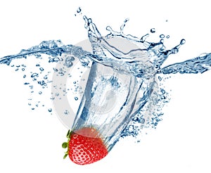 Strawberry falls deeply under water with a big splash. photo