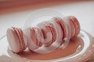 Strawberry french macarons closeup. Fresh and colourful on pink background