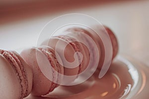 Strawberry french macarons closeup. Fresh and colourful on pink background