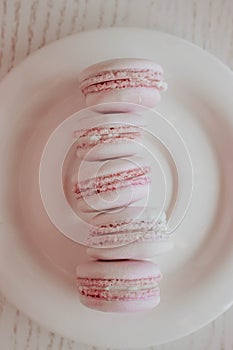 Strawberry french macarons closeup. Fresh and colourful on pink background