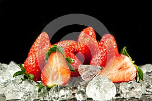 Strawberry on the ice on black background food postcard