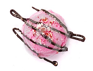 Strawberry ice cream ball with melted chocolate and nuts on white background, top view