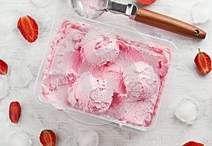 Strawberry ice cream in box on a white background