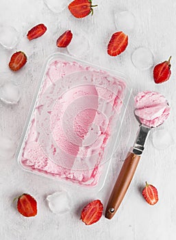 Strawberry ice cream in box on a white background