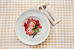 Strawberry ice cream dish with fresh strawberry photo