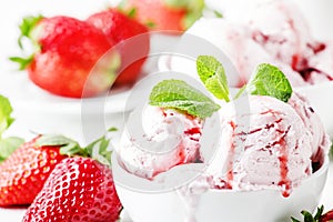 Strawberry ice cream with jam topping, decorated with green mint