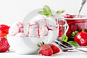 Strawberry ice cream with jam topping, decorated with green mint