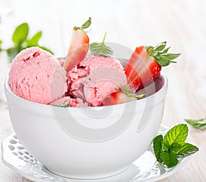 Strawberry ice cream and leaves of mint