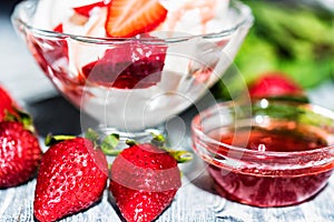 Strawberry ice cream with mint in bowl and jam