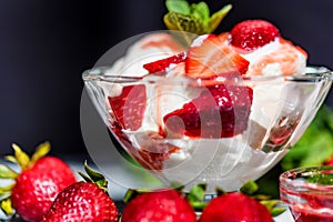 Strawberry ice cream with mint in bowl and jam
