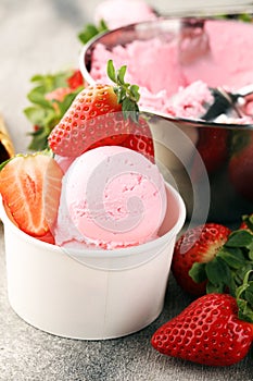 Strawberry ice cream scoop with fresh strawberries and waffle icecream cones