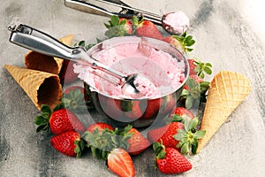 Strawberry ice cream scoop with fresh strawberries and waffle icecream cones