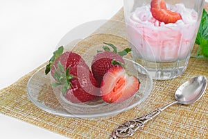 Strawberry ice cream scoop with fresh strawberries on wooden background