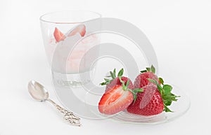 Strawberry ice cream scoop with fresh strawberries on wooden background