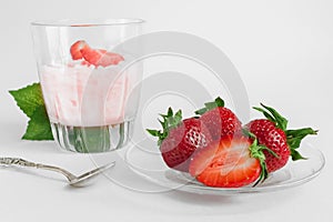 Strawberry ice cream scoop with fresh strawberries on wooden background