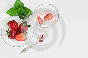 Strawberry ice cream scoop with fresh strawberries on wooden background