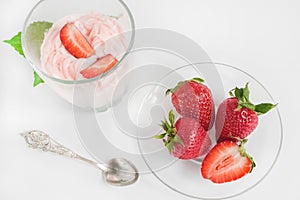 Strawberry ice cream scoop with fresh strawberries on wooden background