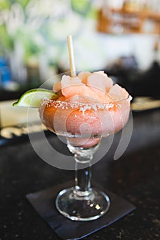 A strawberry jalepeno frozen blended margarita at a local Mexican restaurant bar for cinco de mayo