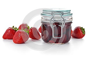 Strawberry jam and berries isolated on white.