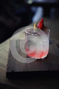 Strawberry juice with soda on wooden plate