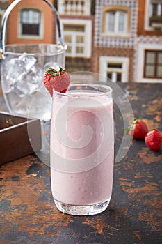 Strawberry Lassi served in glass isolated on table top view of punjabi culture