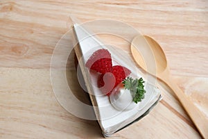 Strawberry layer cake with cream bakery fresh fruit topping individually wrapped. Put on the wooden tray