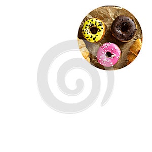 Strawberry, lemon and chocolate donuts on wrapping paper. copy space. white