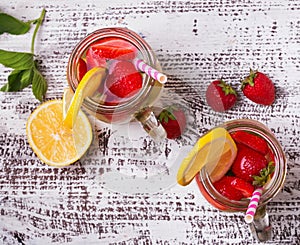 Strawberry and lemon detox water in glass jars