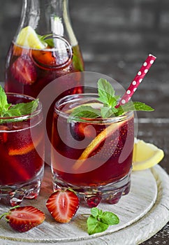 Strawberry lemonade with fresh mint and lemon in glass beakers