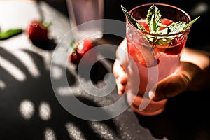 Strawberry lemonade punch. A delightful mix of tangy lemonade and luscious strawberries, served in a glass with ice