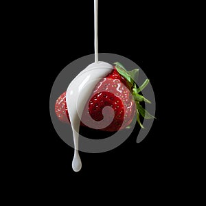 Strawberry Making A Splash. Isolated on black background.