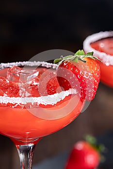 Strawberry margarita cocktail with strawberries and salt rim