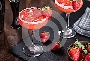 Strawberry margarita cocktail with strawberries and salt rim