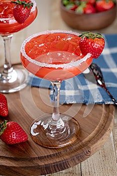 Strawberry margarita cocktail with strawberries and salt rim