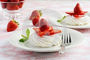Strawberry meringue nests with a fork