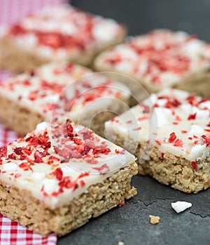 Strawberry and meringue topped flapjack on gingham cloth