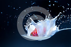 Strawberry with milk splash isolated on black