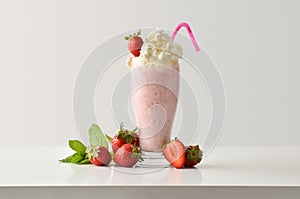 Strawberry milkshake with cream decorated with fruit on table isolated