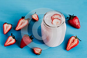 Strawberry milkshake in the glass jar blue vintage background photo