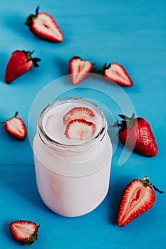 Strawberry milkshake in the glass jar blue vintage background photo