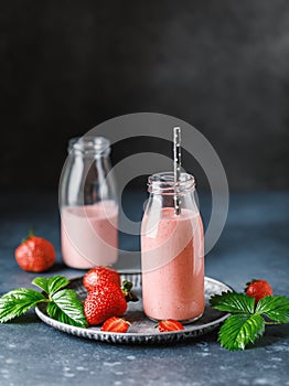 Strawberry milkshake in the glass jar. Strawberry smoothie, healthy food for breakfast and snack