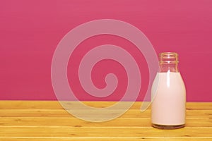Strawberry milkshake in a one-third pint glass milk bottle
