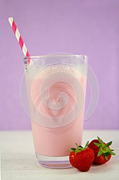 Strawberry milkshake on purple background