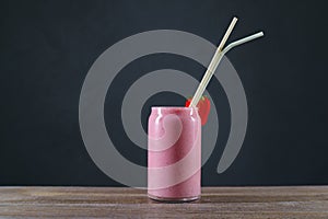 Strawberry milkshake on restaurant table, refreshing cold drink.