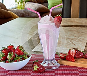 Strawberry milkshake with strawberry syrup decorated with fruit photo