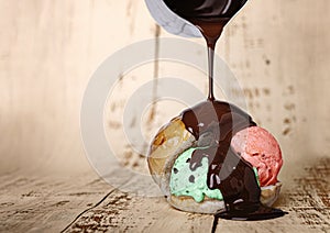 Strawberry and mint ice cream ball inside a milk bread bun, dropping liquid chocolate