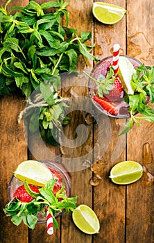 Strawberry mojito summer cocktails with mint and lime in glasses