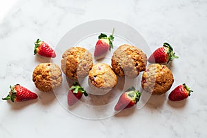 Strawberry muffins on a marble background. Top view