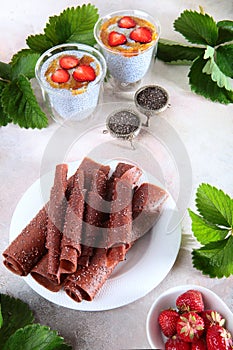 Strawberry pastille on a white plate and Chia seed pudding.Chia seeds in vintage dishes. Vertical photo. Copy of the space. The